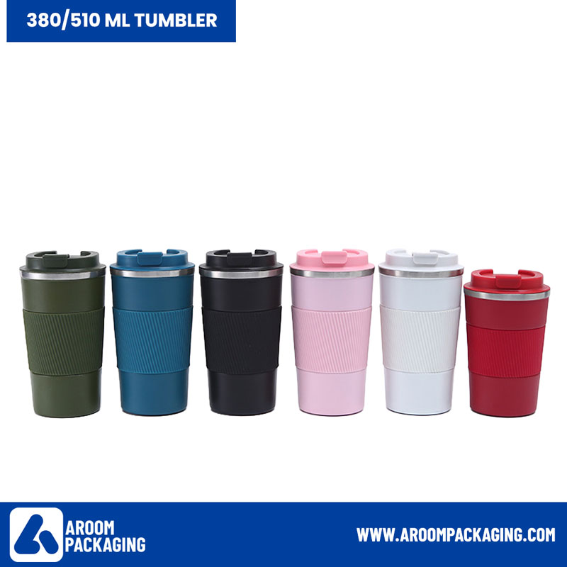 Six reusable travel mugs in green, blue, black, pink, white, and red with ribbed grips, arranged in a row against a plain background.